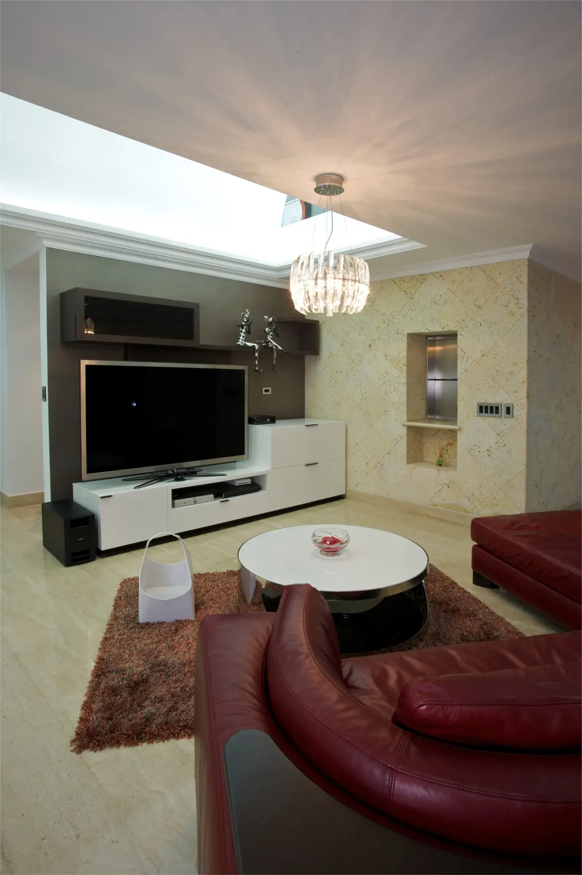 Red sofa with white table and television