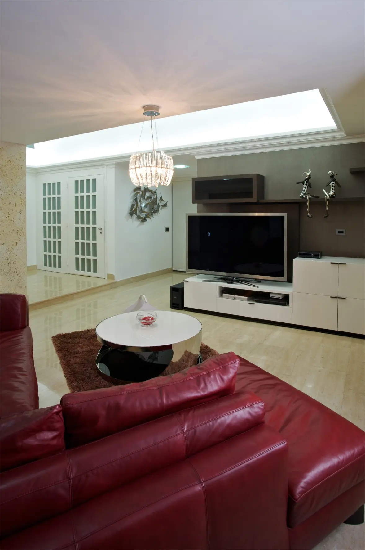 Red sofa with white table and television