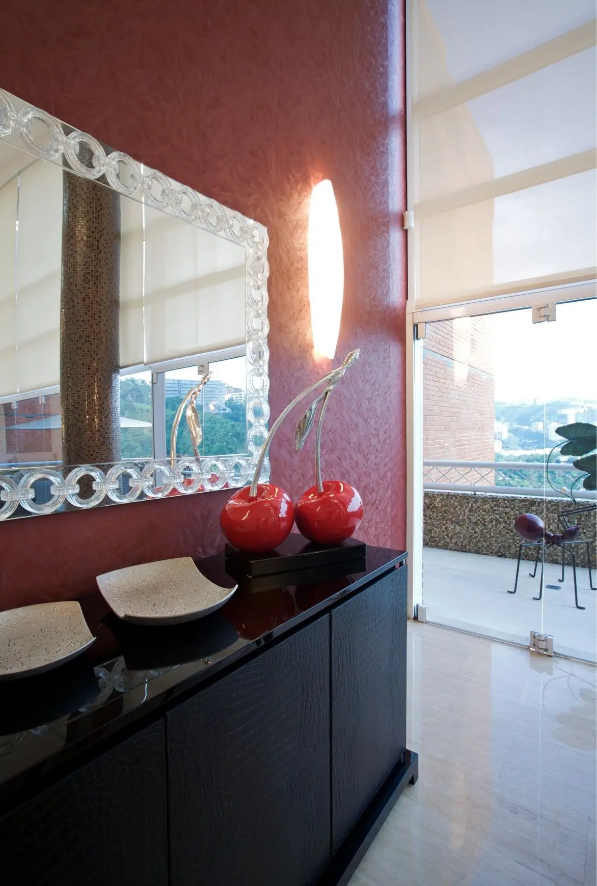 Black furniture with mirror and cherry sculpture