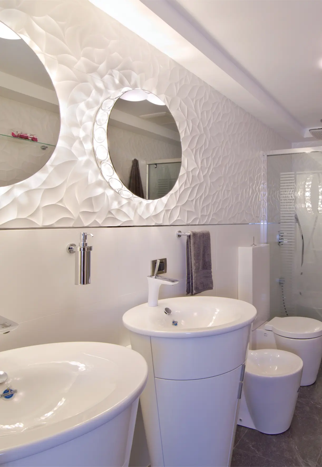 2 sinks with mirrors. Toilet and shower in background