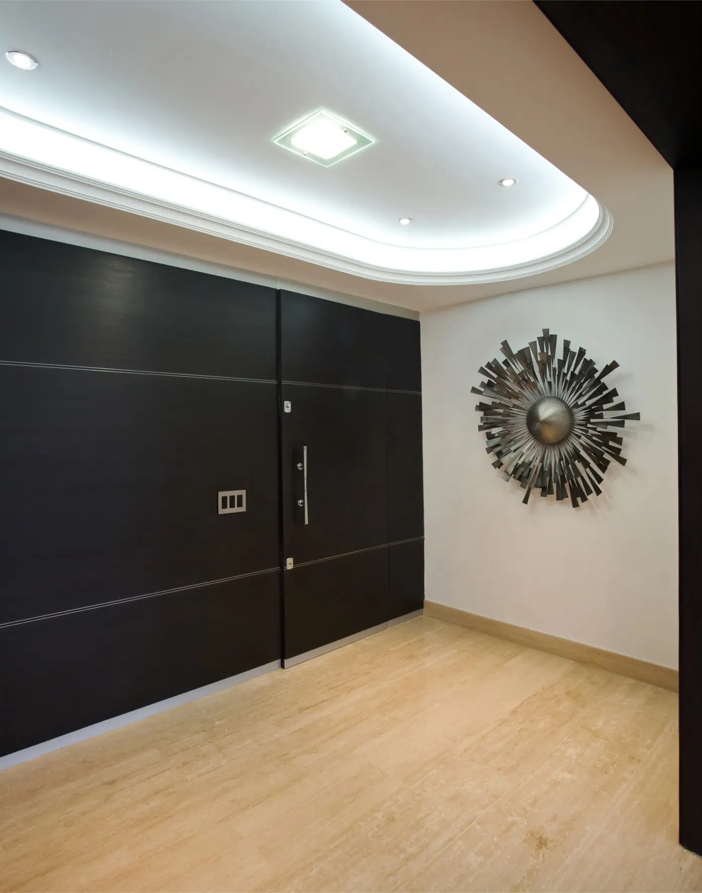 Black entrance door with wall sculpture