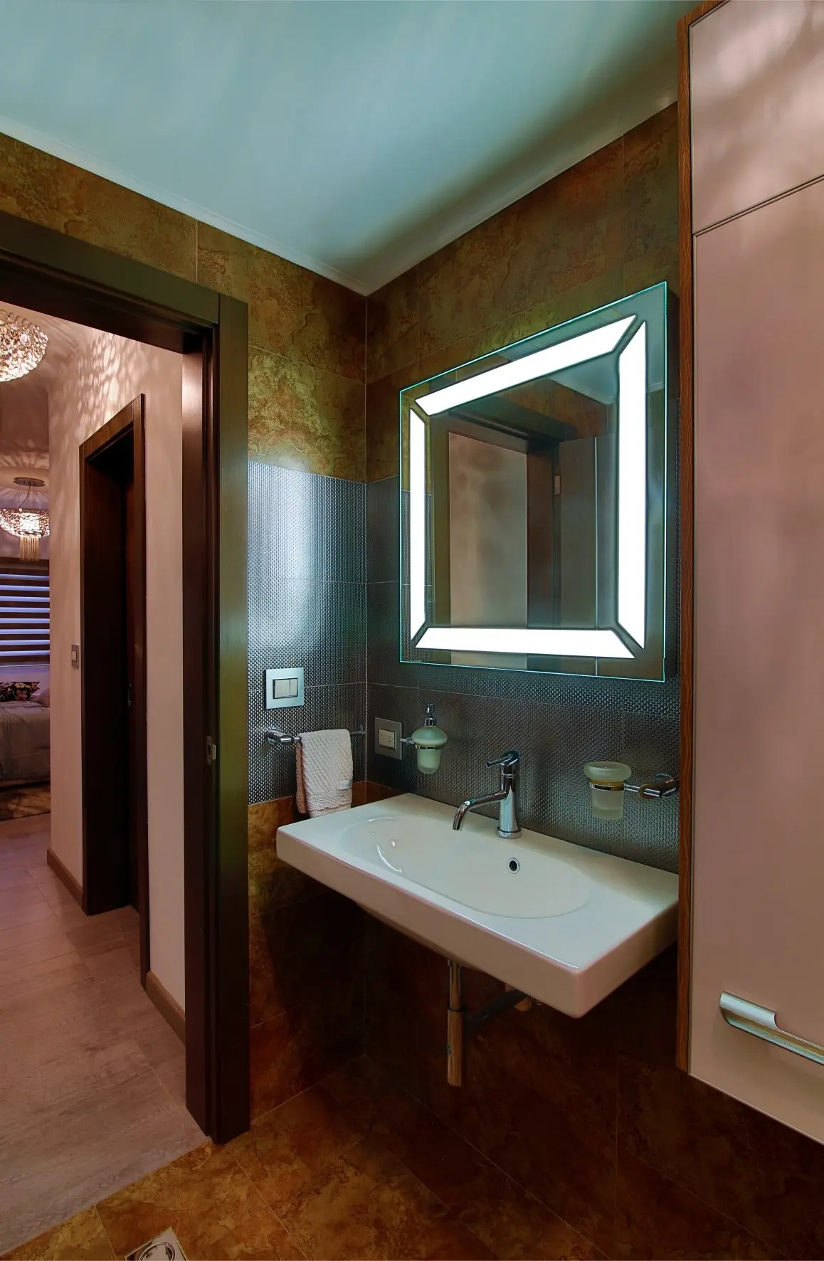 Ocher bathroom with white ceiling and illuminated mirror