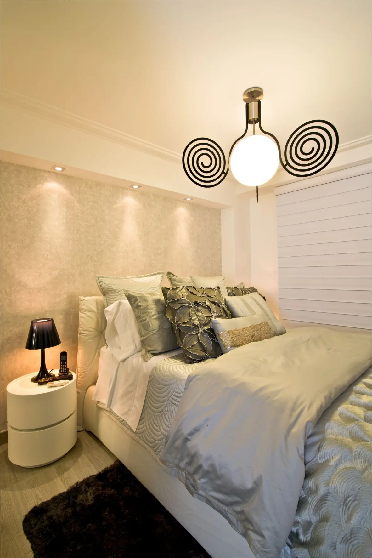 White master bedroom with spiral lamp