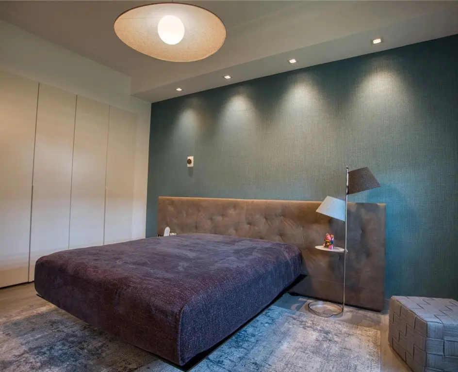 Bedroom with brown bed and dark blue wall