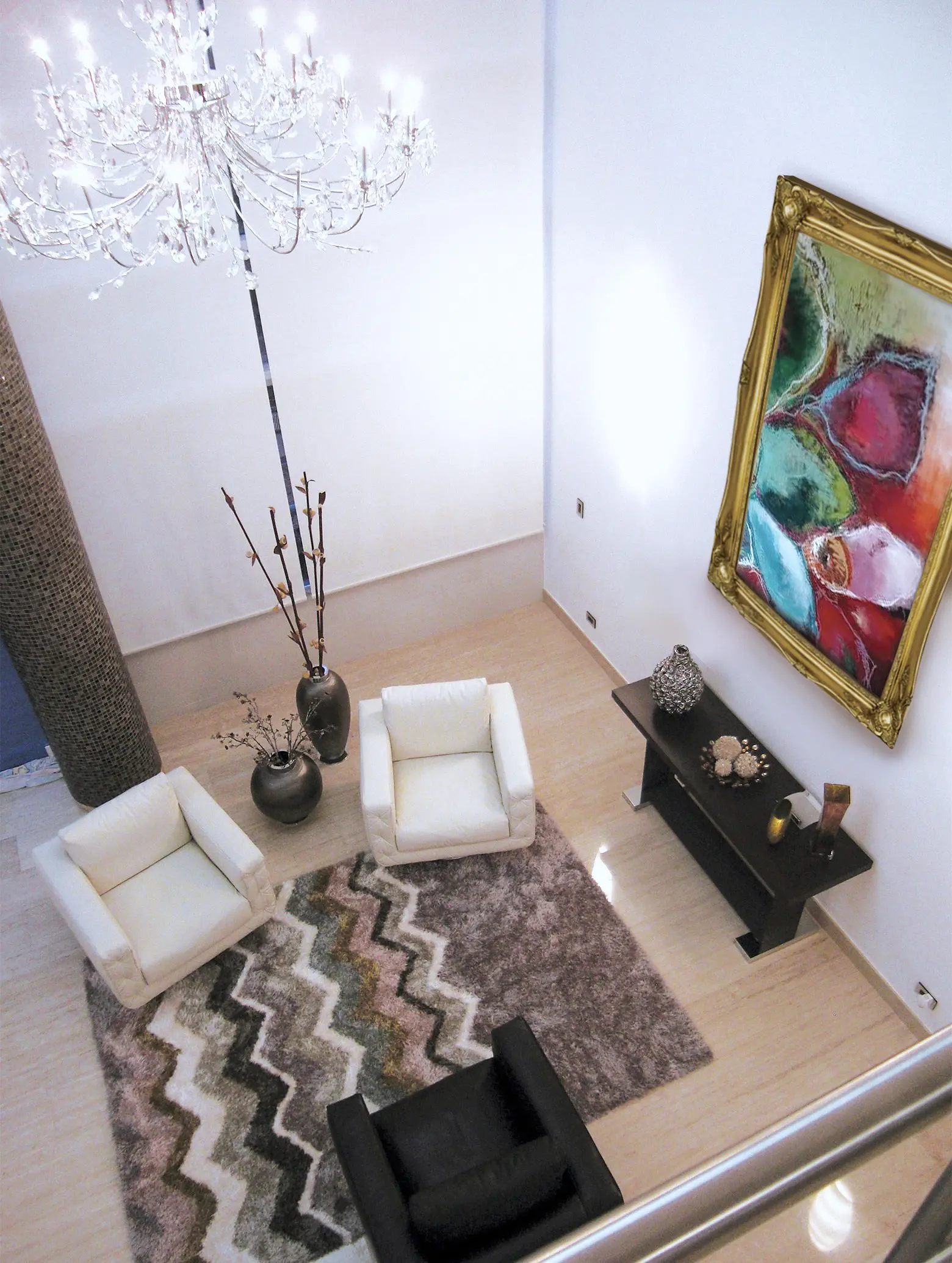 Aereal shot of living room. Painting and chandelier