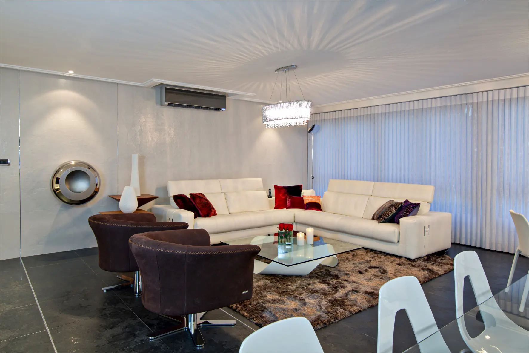 White sofa, brown armchairs and carpet, crystal table and wall fireplace