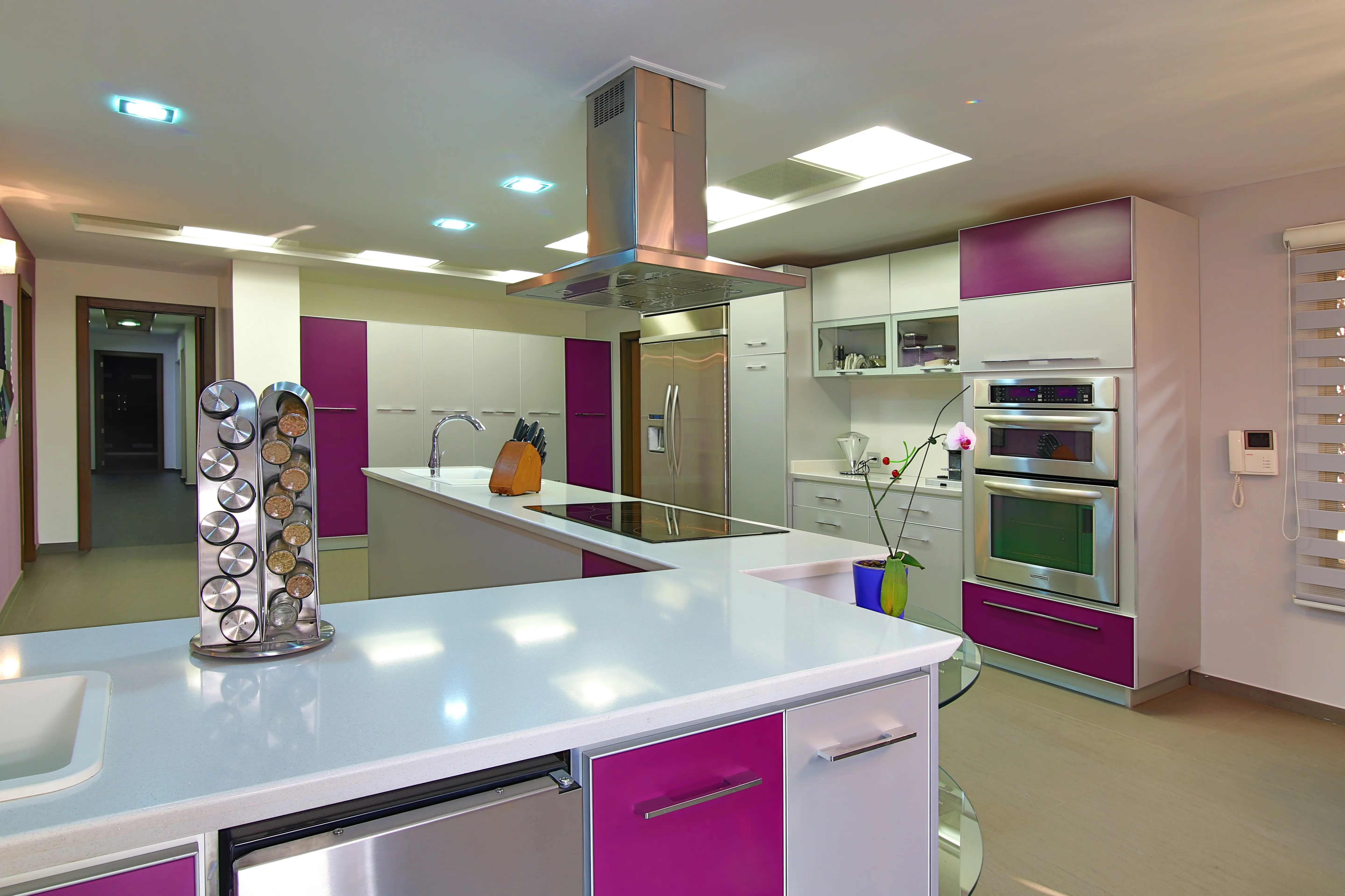 Broad white kitchen with purple details