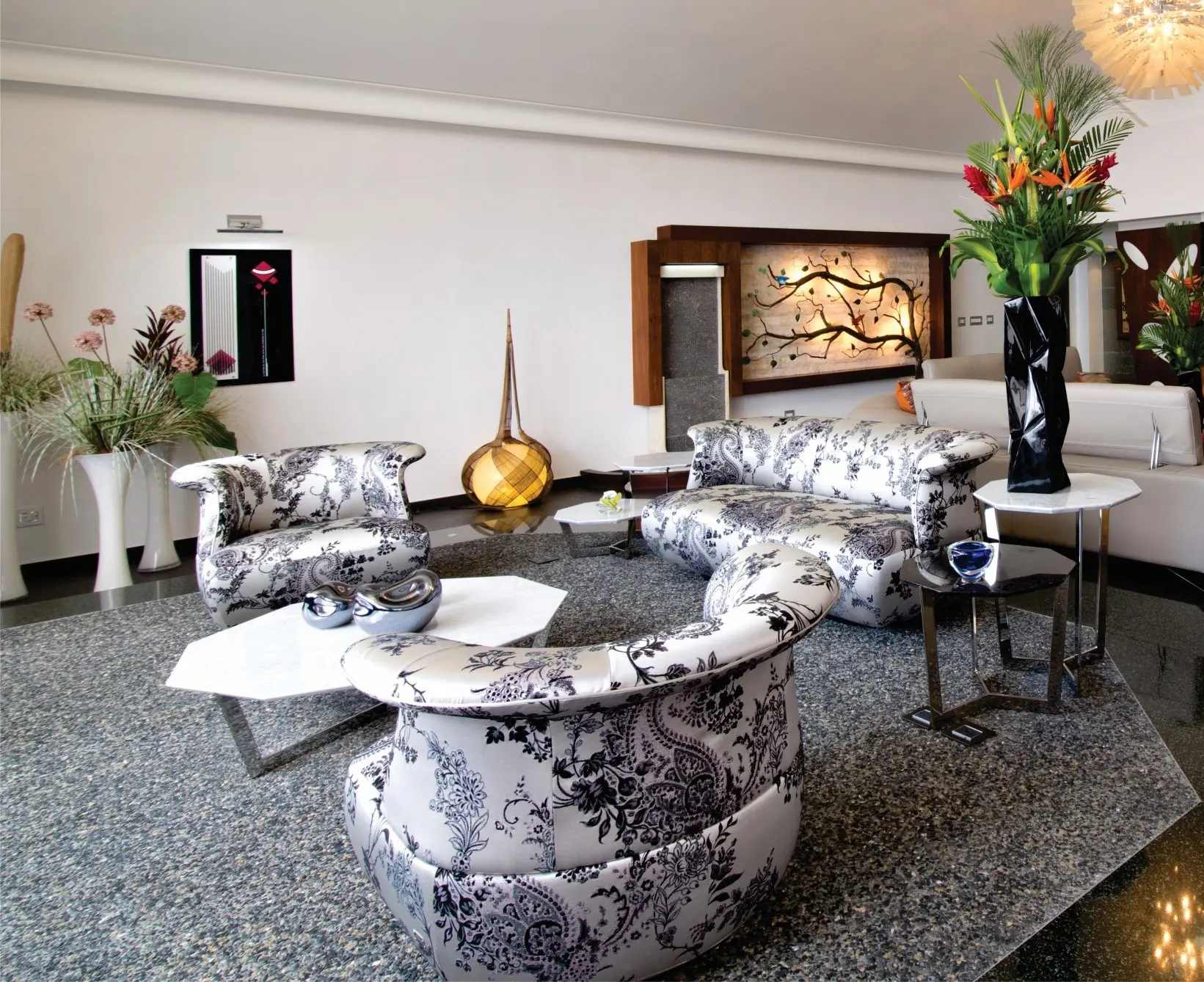 Set of white sofas with black patterns and a white table in the center