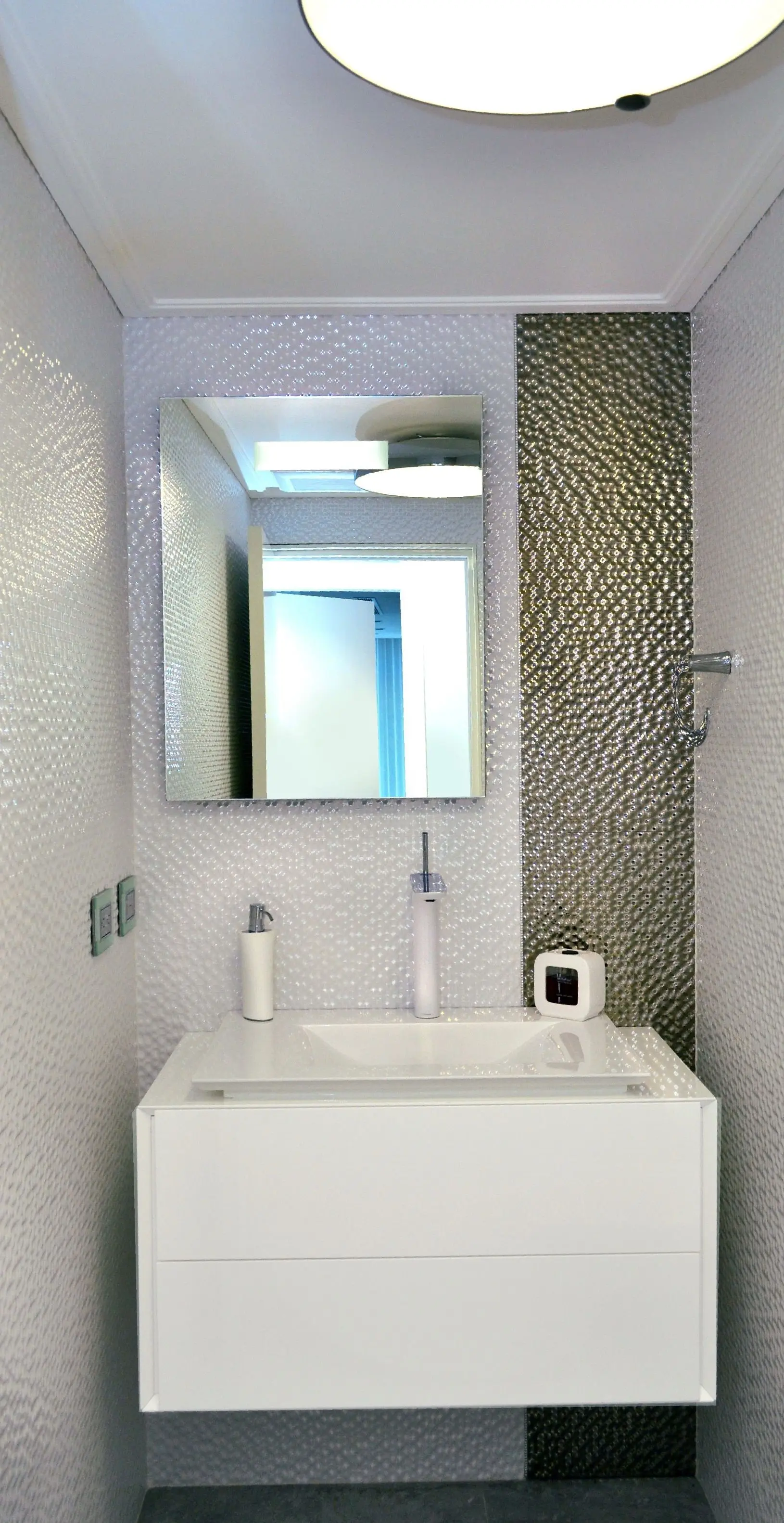 White sink with mirror and silver details