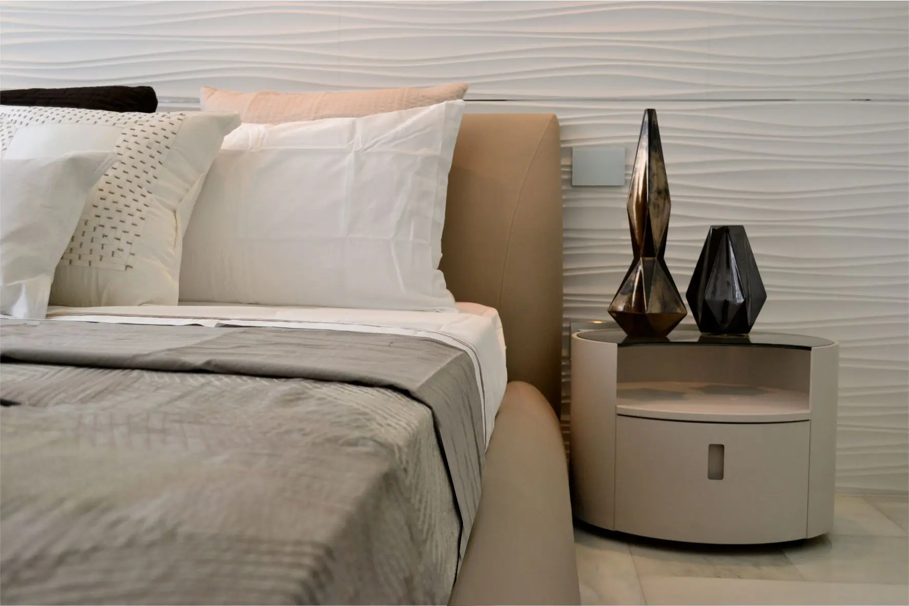 Bed with nightstands and sculptures