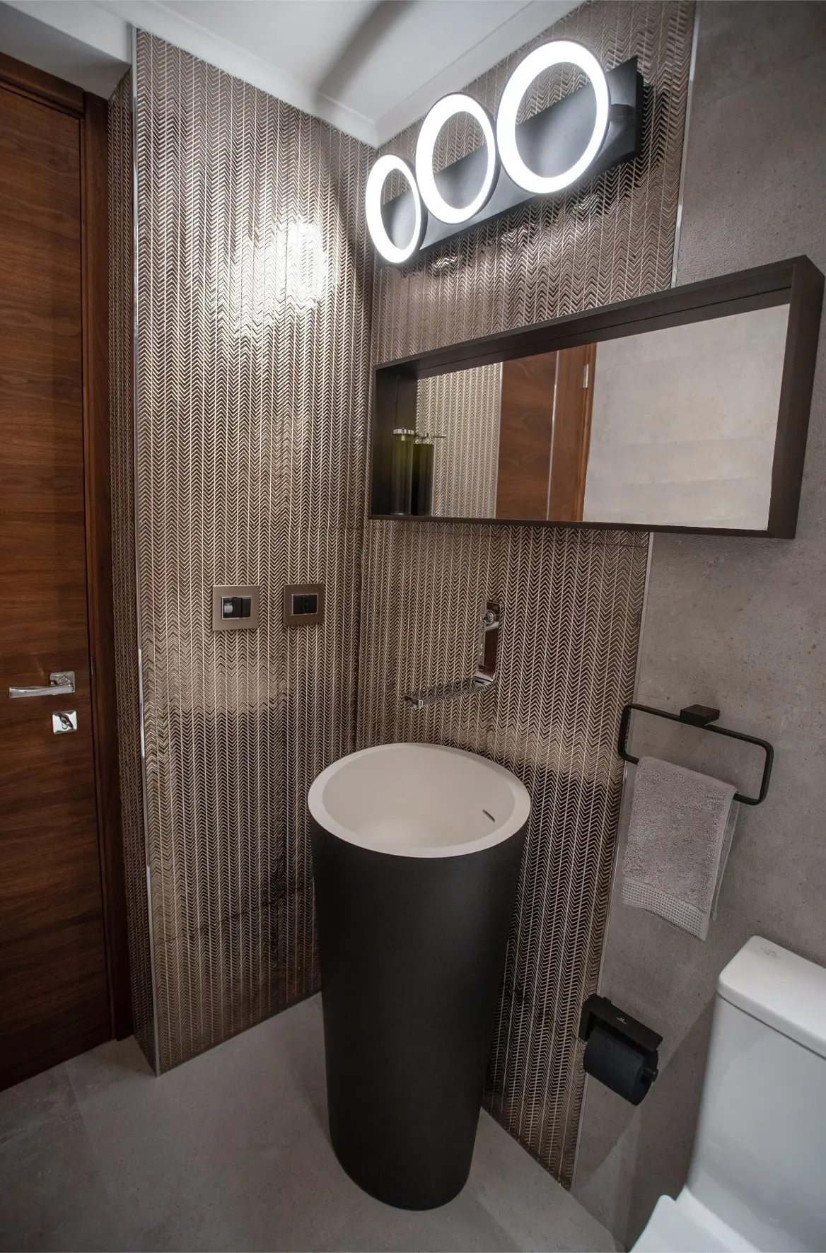 Black sink with mirror and 3 round lamps