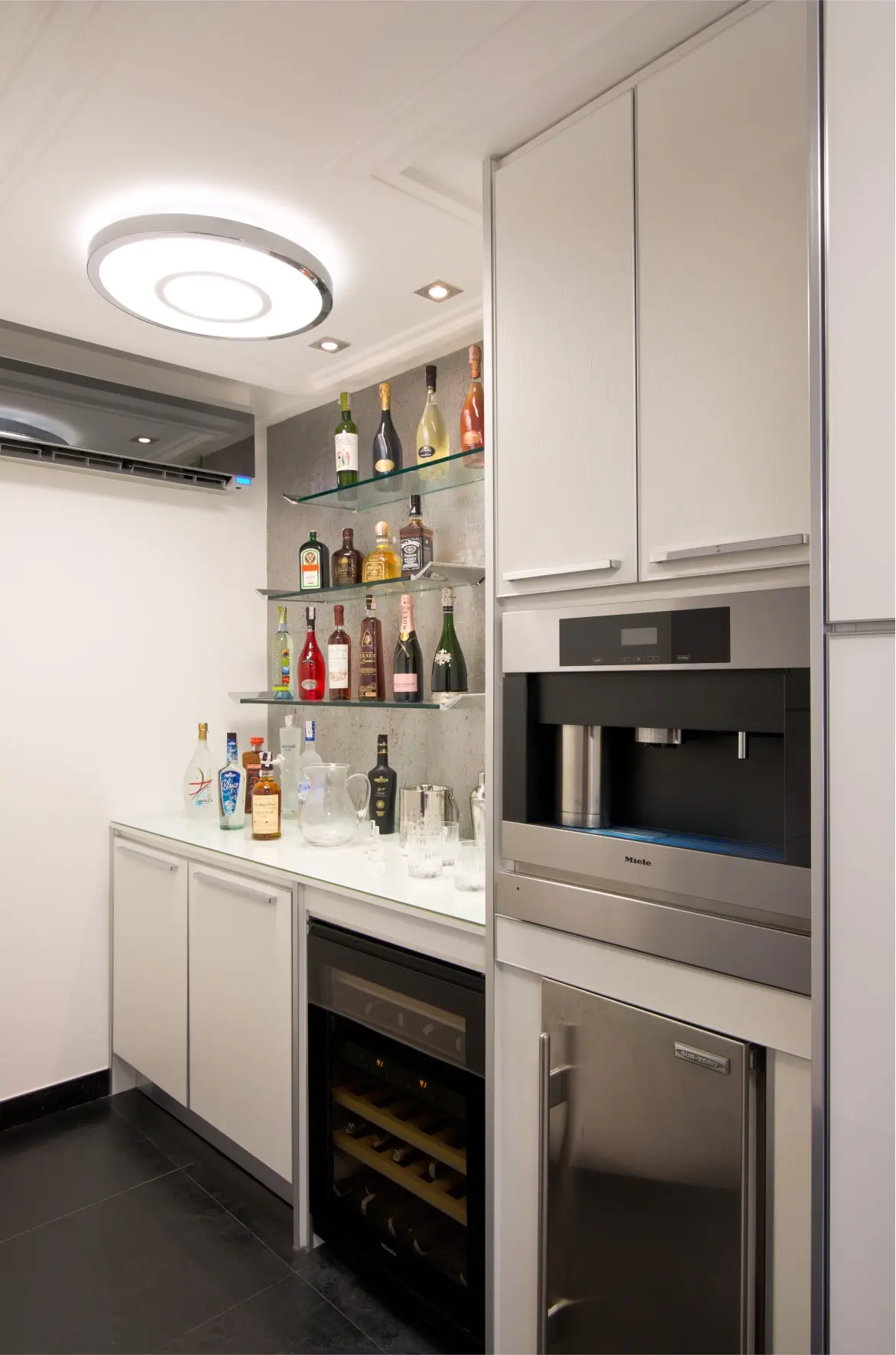 White bar with black ice maker and cooler