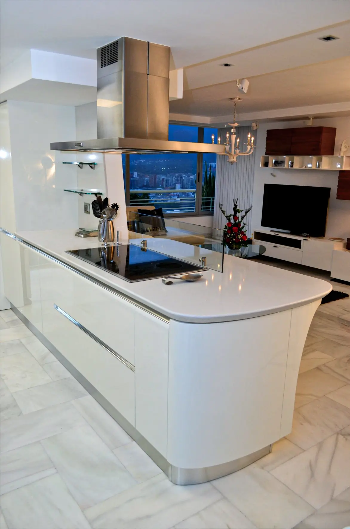 White kitchen with electric stove and silver exhaust hood