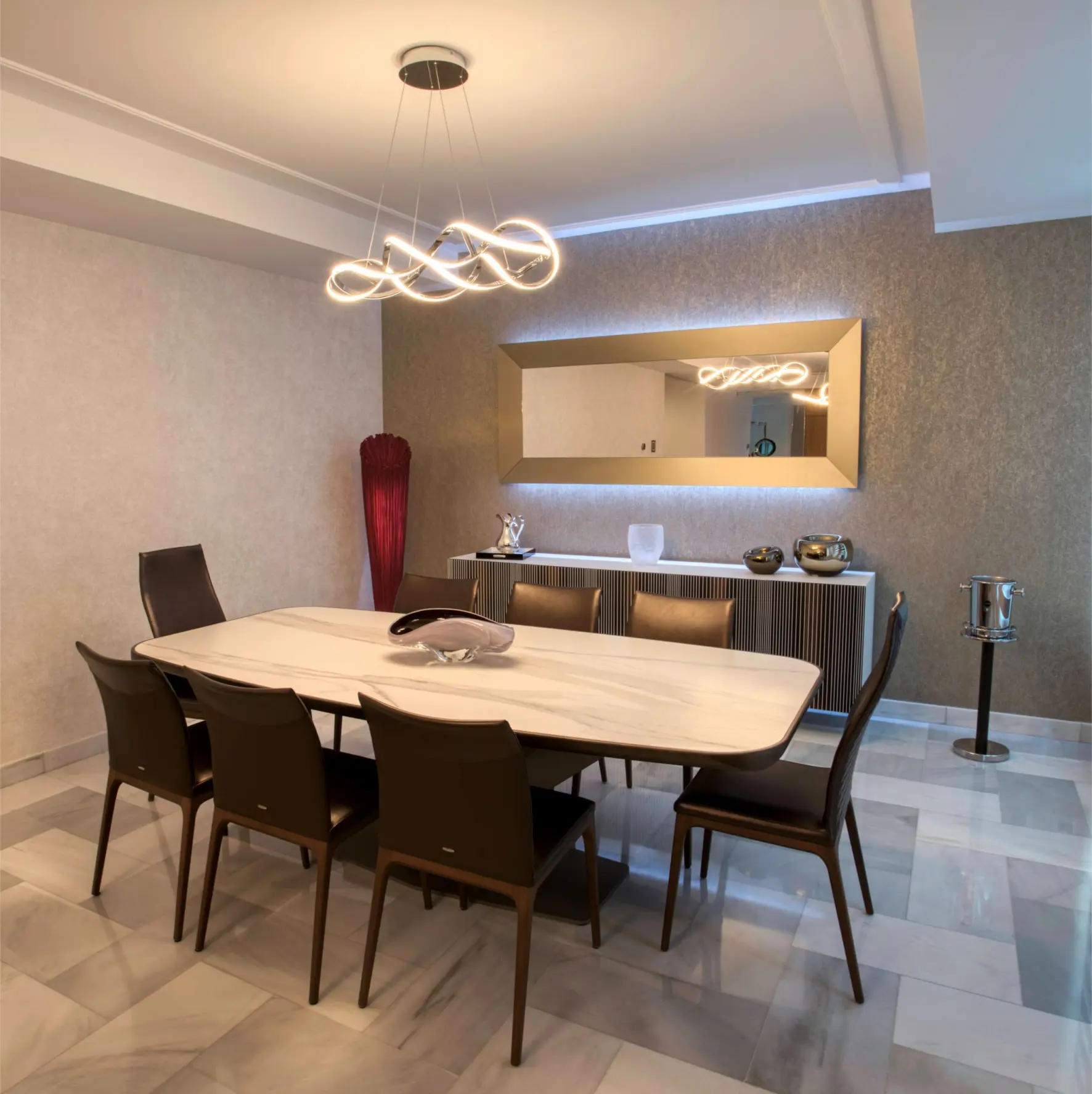 White dining table with brown chairs and mirror in background