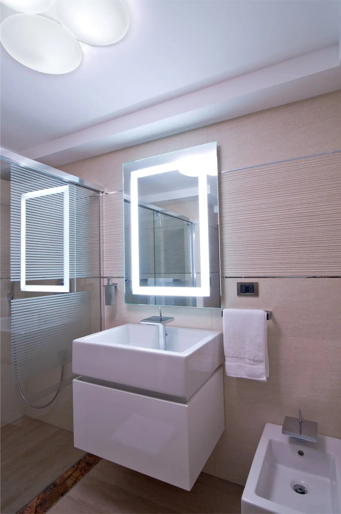 White sink with illuminated mirror