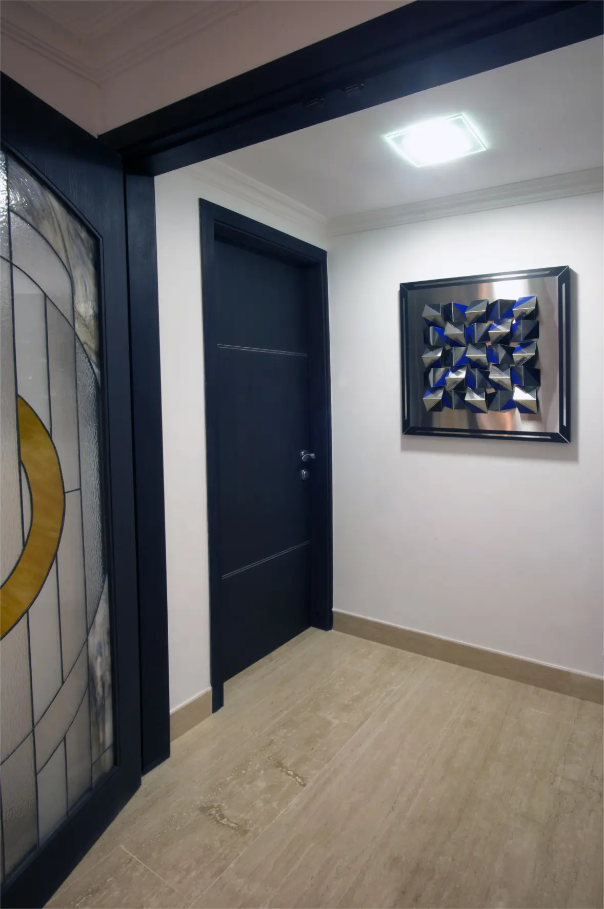 Black door with wall sculpture