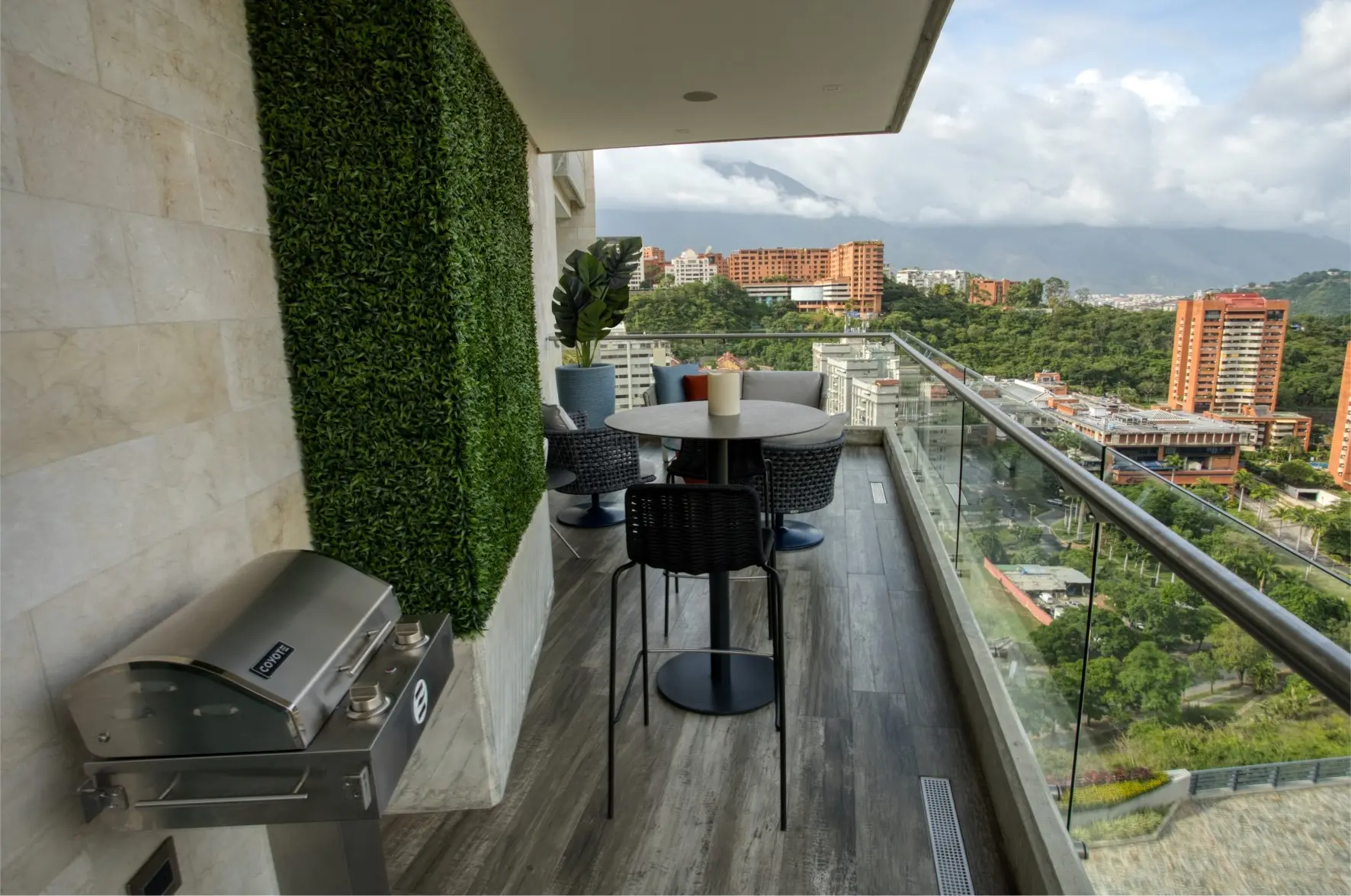 Balcony with green wall and city view