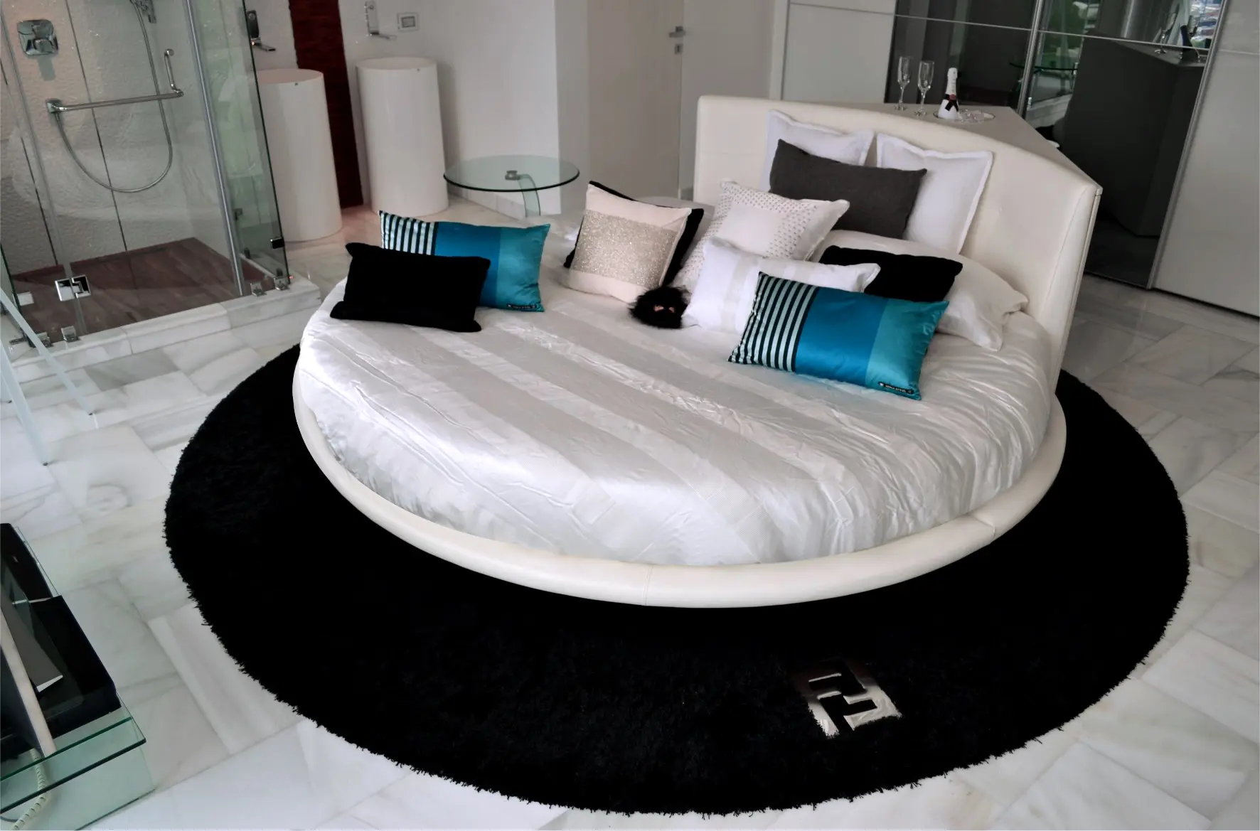 White round bed with Fendi carpet